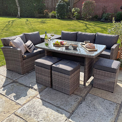 grey rattan outdoor rectangular dining set with sofas, stools, snacks and drinks
