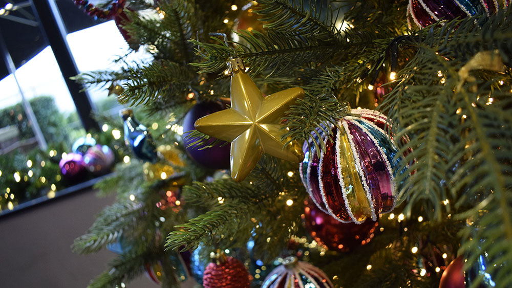 contemporary christmas decoration service for hotel - star and colourful bauble on christmas tree