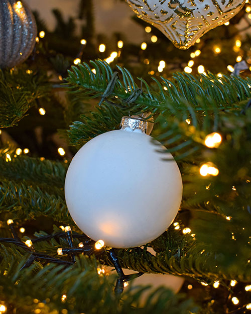 matte white bauble on christmas tree