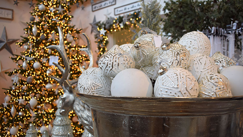 patterned and matte white christmas baubles in silver bowl