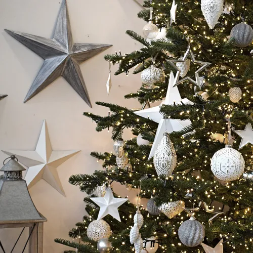 white christmas theme - white baubles and stars on tree with lantern