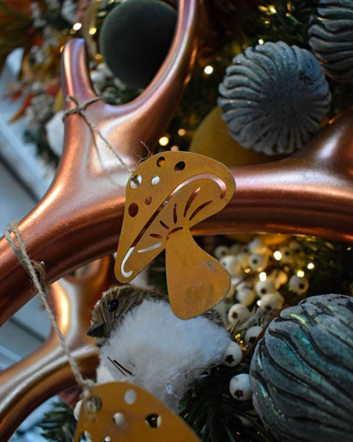 brass metal mushroom woodland christmas decoration hanging of metallic antler with rsutic bird and green bauble